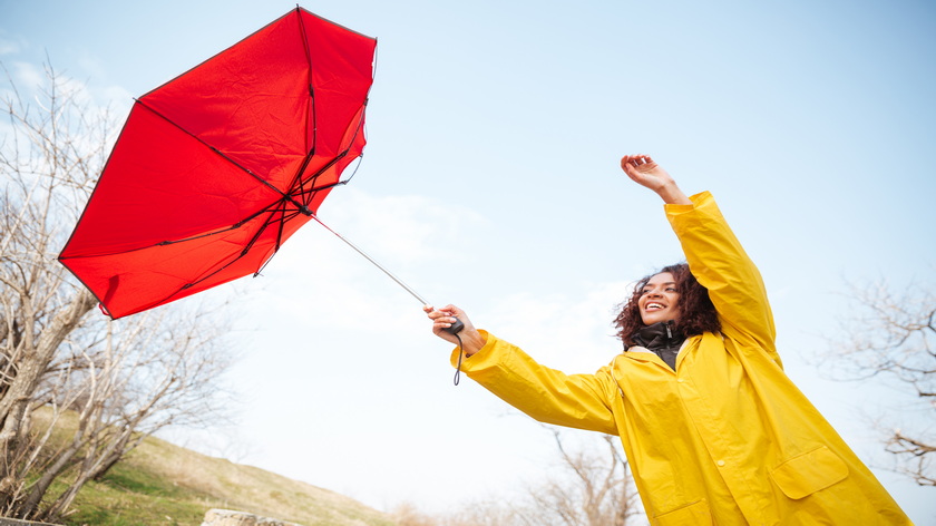 woman-catching-flying-umbrella